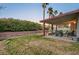 Backyard with patio, grass and a hedge at 6466 Scotch Pine Cir, Las Vegas, NV 89146