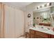 Bathroom with shower, toilet and wood vanity at 6466 Scotch Pine Cir, Las Vegas, NV 89146