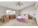 Spacious bedroom with king-size bed and ceiling fan at 6466 Scotch Pine Cir, Las Vegas, NV 89146