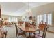 Elegant dining room with a chandelier and large windows at 6466 Scotch Pine Cir, Las Vegas, NV 89146