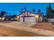 Two-car garage with white doors and brick exterior at 6466 Scotch Pine Cir, Las Vegas, NV 89146
