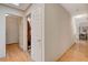 Bright hallway with light wood floors and doors to bedrooms at 6466 Scotch Pine Cir, Las Vegas, NV 89146