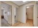 Hallway with light wood floors and access to laundry at 6466 Scotch Pine Cir, Las Vegas, NV 89146