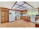 Modern kitchen with wood cabinets and white appliances at 6466 Scotch Pine Cir, Las Vegas, NV 89146