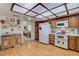 Bright kitchen featuring wood cabinets, white appliances, and wood flooring at 6466 Scotch Pine Cir, Las Vegas, NV 89146