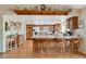 Eat-in kitchen with wood cabinets, island seating, and wood floors at 6466 Scotch Pine Cir, Las Vegas, NV 89146