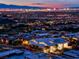 Luxury home at night with city lights and mountain backdrop at 686 Tranquil Rim Ct, Henderson, NV 89012