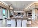 Open concept dining area with large table and chandelier at 686 Tranquil Rim Ct, Henderson, NV 89012