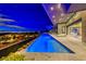 Modern pool and spa at night with city views at 686 Tranquil Rim Ct, Henderson, NV 89012