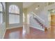 Living room with hardwood floors, staircase, and large window at 8113 Bay Springs Dr, Las Vegas, NV 89128