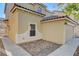 Tan two-story house with garage and walkway, next to another house at 881 Blushing Rose Pl, Henderson, NV 89052