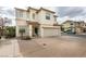 Two-story house with attached garage, driveway and landscaping at 9100 Spoonbill Ridge Pl, Las Vegas, NV 89143