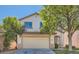 Two-story house with beige exterior, attached garage, and grassy front yard at 9893 Canyon Peak Dr, Las Vegas, NV 89147