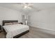 Bright bedroom with ceiling fan, wood-look floors and large window at 104 Masserta Ct, Las Vegas, NV 89183