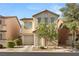 Two-story house with beige siding, a two-car garage, and landscaping at 104 Masserta Ct, Las Vegas, NV 89183