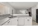 Kitchen with white cabinets, gray countertops, and stainless steel appliances at 104 Masserta Ct, Las Vegas, NV 89183