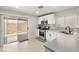 Kitchen with white cabinets, stainless steel appliances, and backyard access at 104 Masserta Ct, Las Vegas, NV 89183