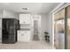 Modern kitchen features white cabinets, stainless steel appliances, and access to backyard at 104 Masserta Ct, Las Vegas, NV 89183