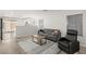 Living room with gray sofa, recliner, and a wood-look floor at 104 Masserta Ct, Las Vegas, NV 89183