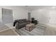 Living room with gray sofa, recliner, and wood-look floors at 104 Masserta Ct, Las Vegas, NV 89183