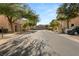 Quiet residential street with houses and trees at 104 Masserta Ct, Las Vegas, NV 89183