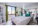 Bedroom with a full-size bed and large window at 3930 University Center Dr # 307, Las Vegas, NV 89119