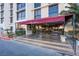 Building entrance with awning, signage, and seating at 3930 University Center Dr # 307, Las Vegas, NV 89119