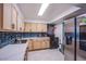 Modern kitchen with light wood cabinets and blue tile backsplash at 3930 University Center Dr # 307, Las Vegas, NV 89119
