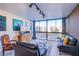 Living room with large windows, city views and comfortable seating at 3930 University Center Dr # 307, Las Vegas, NV 89119