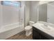 Clean bathroom with tub shower combo, toilet and vanity with dark brown cabinets at 480 Sterling Falls Ave, Henderson, NV 89011