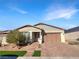 Single-story home with gray siding, brown garage door, and landscaped front yard at 480 Sterling Falls Ave, Henderson, NV 89011