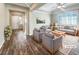 Virtually staged living room with gray sofas, wood floors and entryway at 480 Sterling Falls Ave, Henderson, NV 89011