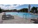 Community pool with lounge chairs and patio umbrellas at 480 Sterling Falls Ave, Henderson, NV 89011