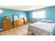 Bedroom with light blue walls, wood flooring, and dresser at 523 Fir St, Boulder City, NV 89005