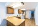 Galley kitchen with wood cabinets and laminate flooring at 523 Fir St, Boulder City, NV 89005