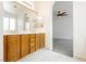 Bathroom featuring a double sink vanity, arched mirrors and bedroom access at 561 Tecate Valley St, Las Vegas, NV 89138