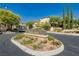 Community entrance with a sign that reads 'Solano' and tall trees on a sunny day at 561 Tecate Valley St, Las Vegas, NV 89138