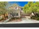 Charming two-story home with a well-manicured front yard, mature trees, and a two-car garage at 561 Tecate Valley St, Las Vegas, NV 89138