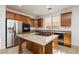 Kitchen with stainless steel appliances, island cooktop, and tile floors at 561 Tecate Valley St, Las Vegas, NV 89138