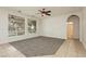 Carpeted living room with neutral walls, ceiling fan, and natural light at 561 Tecate Valley St, Las Vegas, NV 89138