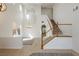 Bright living room with tile floors, stairs, and modern chandelier at 561 Tecate Valley St, Las Vegas, NV 89138