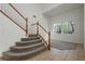 View of the stairs and living room with white walls and tile floors at 561 Tecate Valley St, Las Vegas, NV 89138