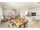 Open concept living area featuring tile flooring, a ceiling fan, and an island with barstool seating at 561 Tecate Valley St, Las Vegas, NV 89138