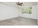 Large main bedroom with plush carpeting, tray ceiling, and large window overlooking the backyard at 561 Tecate Valley St, Las Vegas, NV 89138