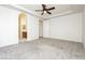 Large main bedroom with plush carpeting, ceiling fan, and doorway to the main bathroom at 561 Tecate Valley St, Las Vegas, NV 89138