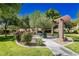 Community park featuring a gazebo, green grass, and flowering bushes at 561 Tecate Valley St, Las Vegas, NV 89138