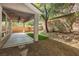 Covered patio includes ceiling fans and string lights overlooking the backyard at 561 Tecate Valley St, Las Vegas, NV 89138