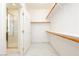Walk-in closet with wooden shelves, closet door and shower room views at 561 Tecate Valley St, Las Vegas, NV 89138