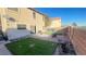 Small backyard with patio, artificial turf, and fire pit at 59 Dreamy Hill Ave, North Las Vegas, NV 89031