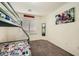 Bedroom featuring a bunk bed with sports-themed bedding, carpet flooring, and a window at 5908 Beluga Bay St, North Las Vegas, NV 89081